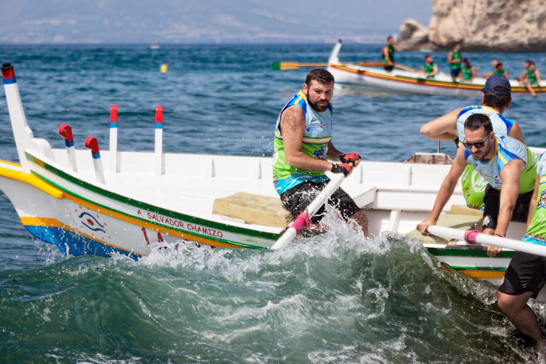 man in green and white life vest riding on green and yellow kayak during daytime