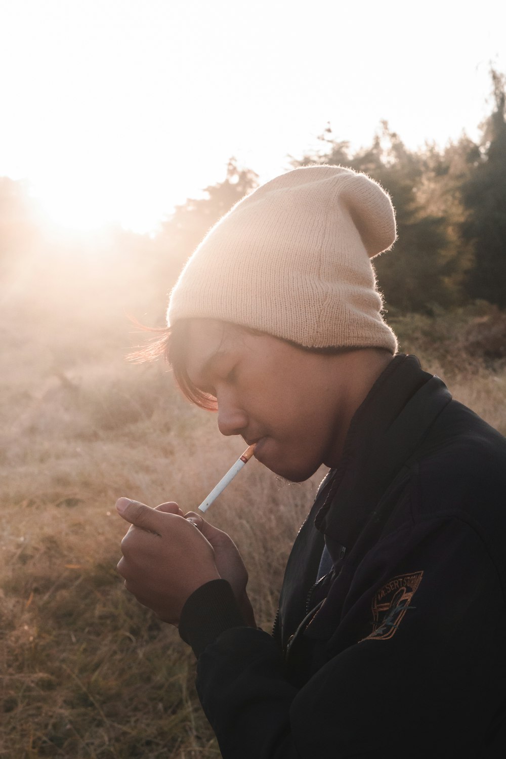 woman in white knit cap smoking cigarette