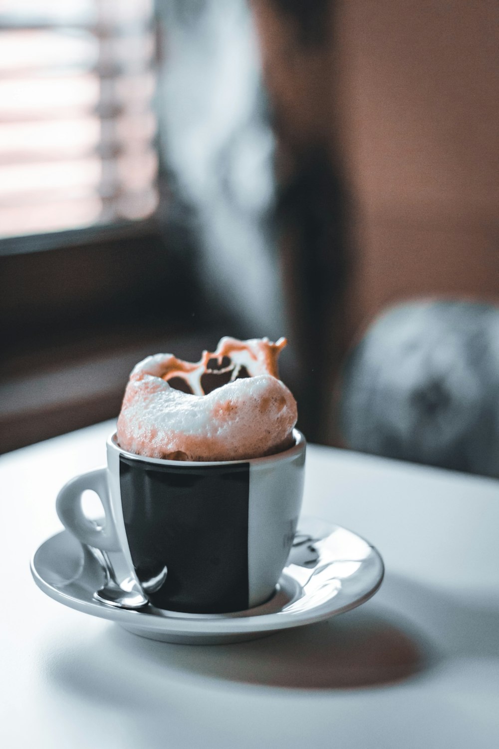 black ceramic mug on white ceramic saucer