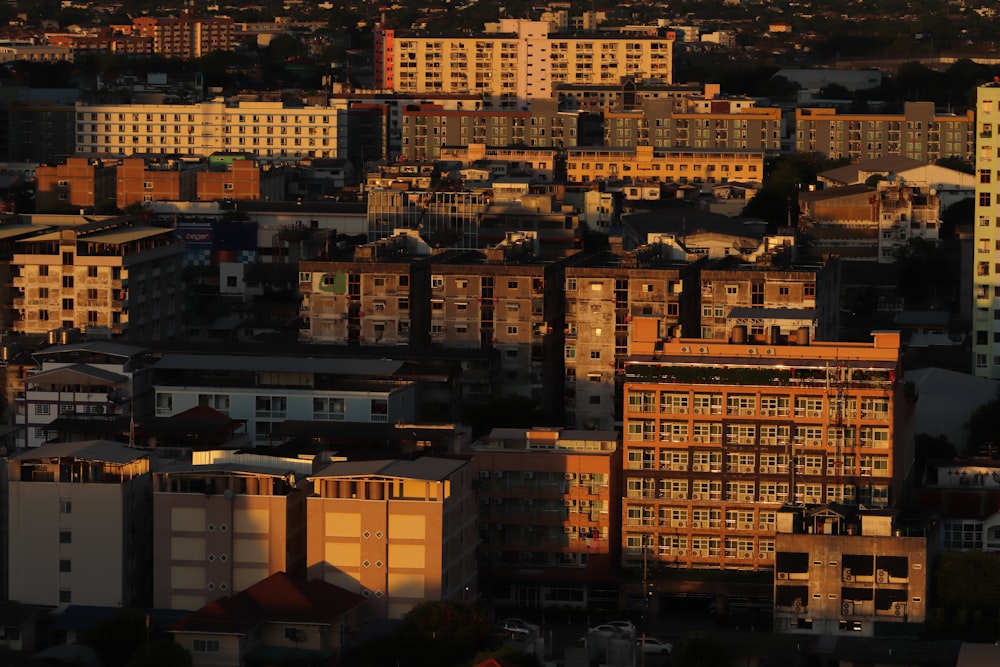 a view of a city at sunset with buildings in the foreground