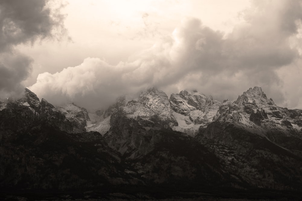 black and white mountains under white clouds