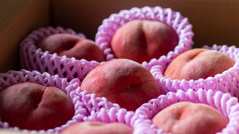 brown round fruit on white and pink knit textile