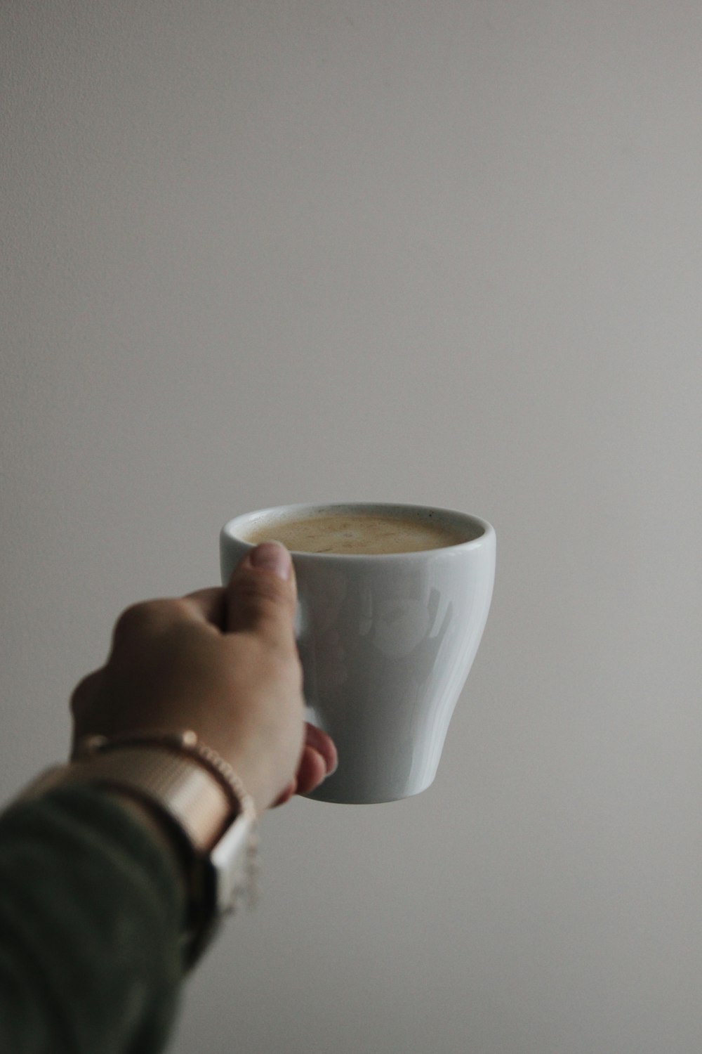 person holding white ceramic mug