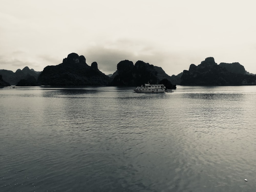 grayscale photo of boat on sea