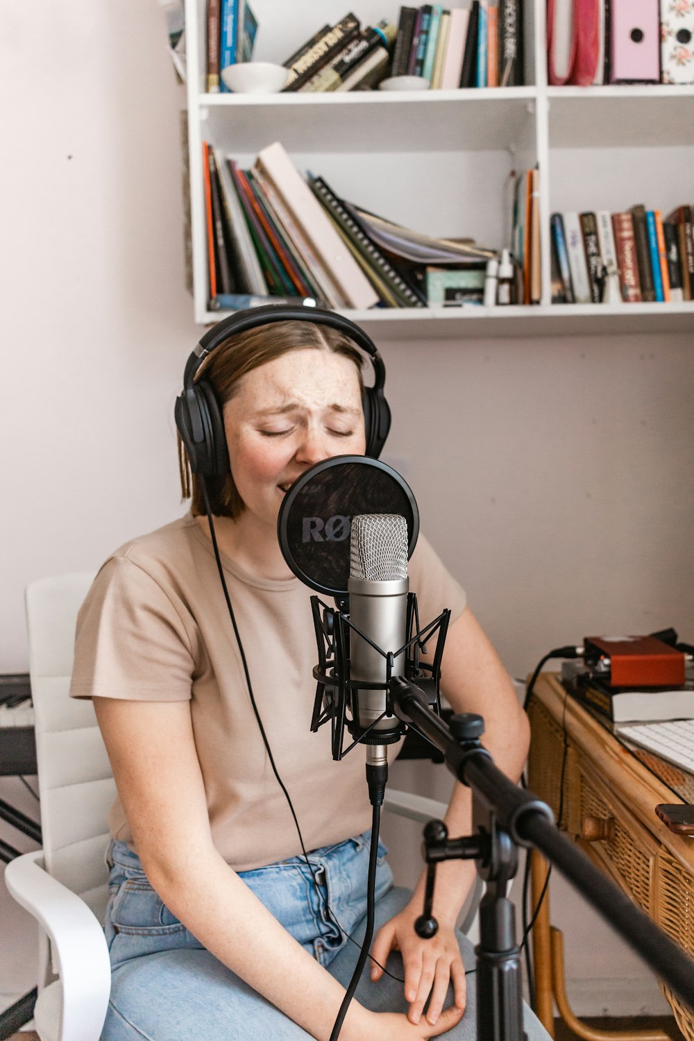 woman in white t-shirt standing beside microphone