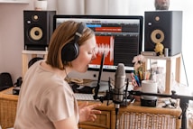 woman in white shirt sitting on chair in front of computer