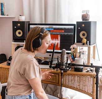 woman in white shirt sitting on chair in front of computer