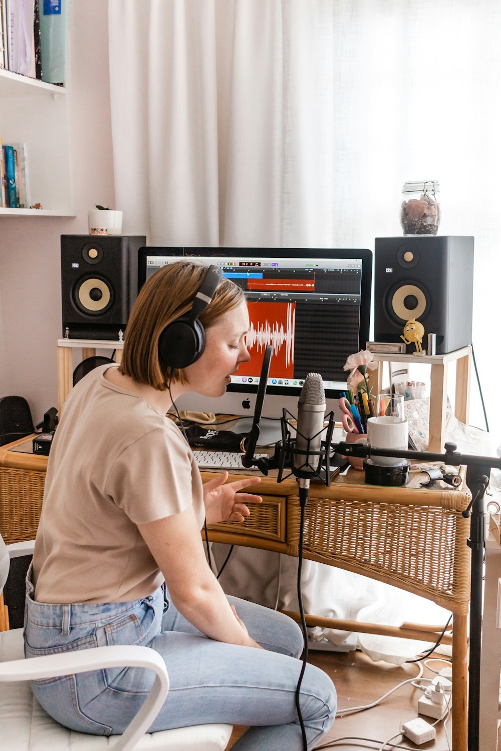 woman in white shirt sitting on chair in front of computer