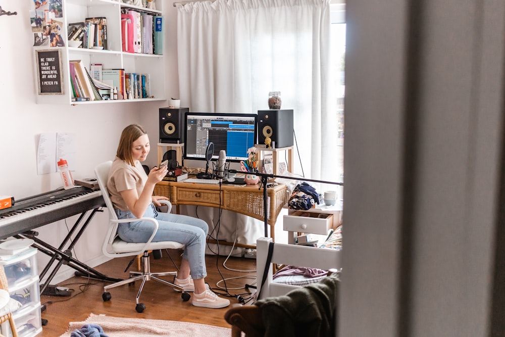 woman in white shirt sitting on chair