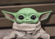 green frog plush toy on brown textile
