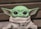 green frog plush toy on brown textile