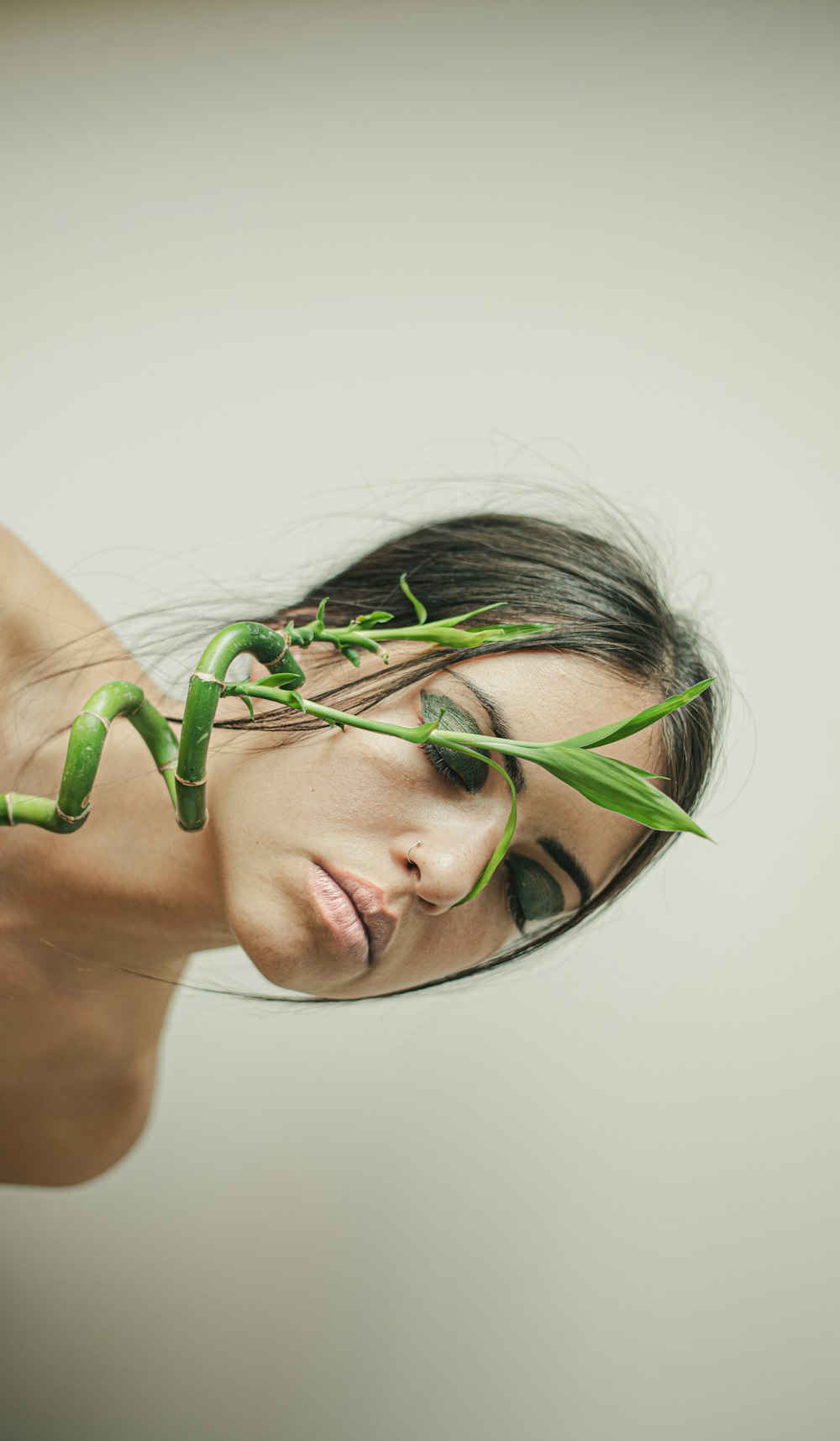 woman with green string lights on her face