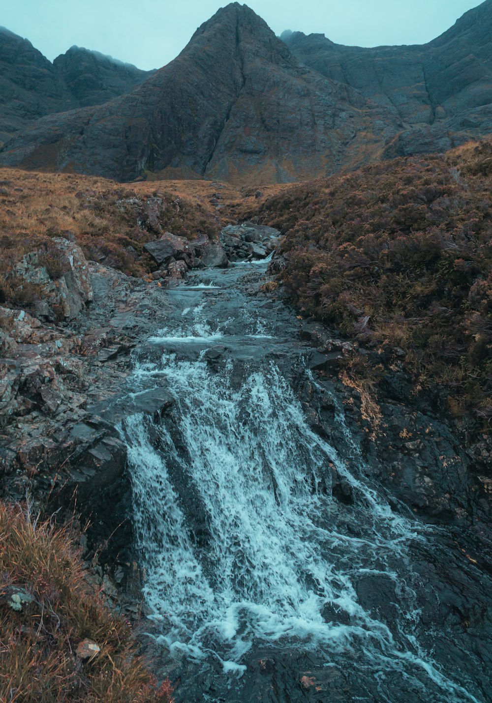 water falls on rocky mountain