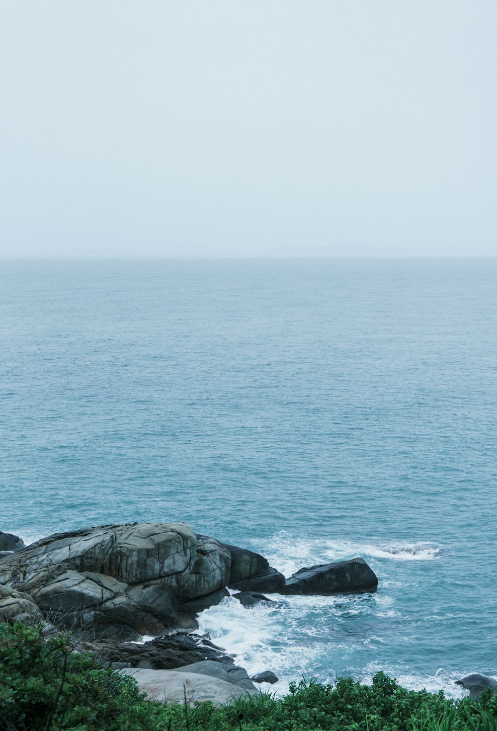 gray rock formation on sea during daytime