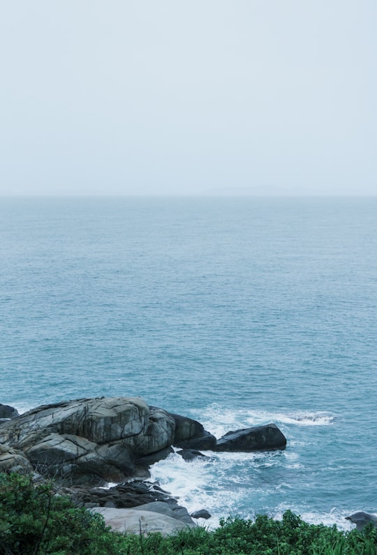 gray rock formation on sea during daytime in Sanya China