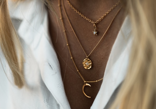 woman wearing gold necklace and white shirt