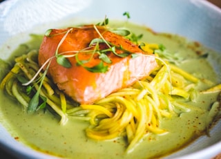 pasta with green leaf on white ceramic plate