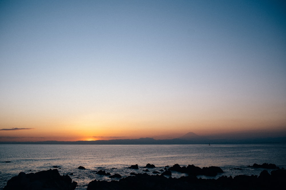 body of water during sunset