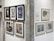 A vibrant gallery wall showcasing various framed artworks, featuring iconic figures and abstract designs.