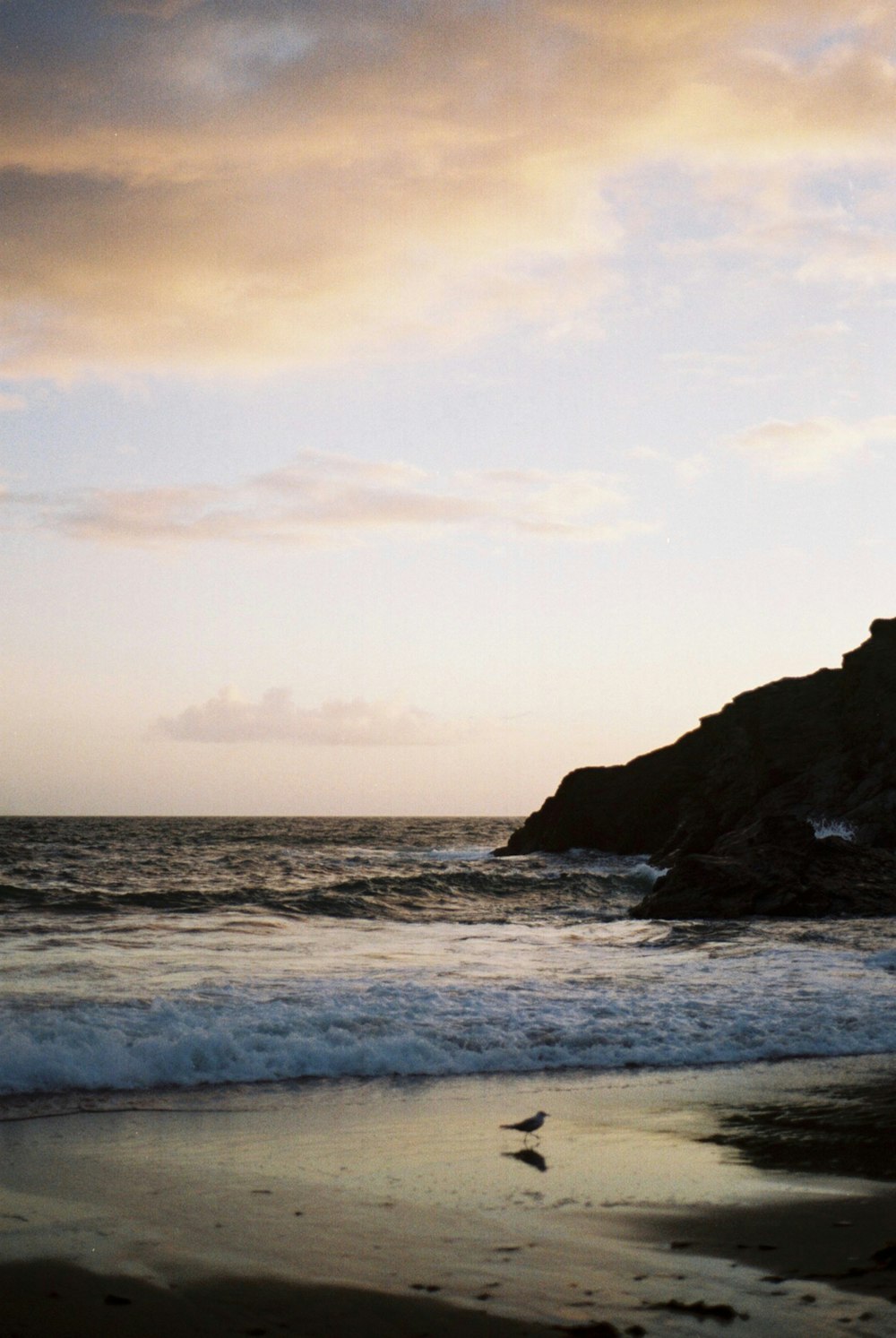 ocean waves crashing on shore during daytime