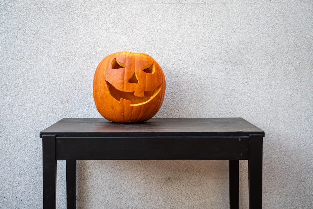 jack o lantern on black wooden table