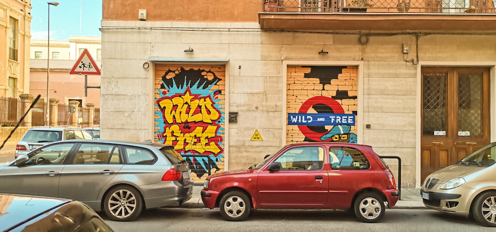 a couple of cars parked in front of a building