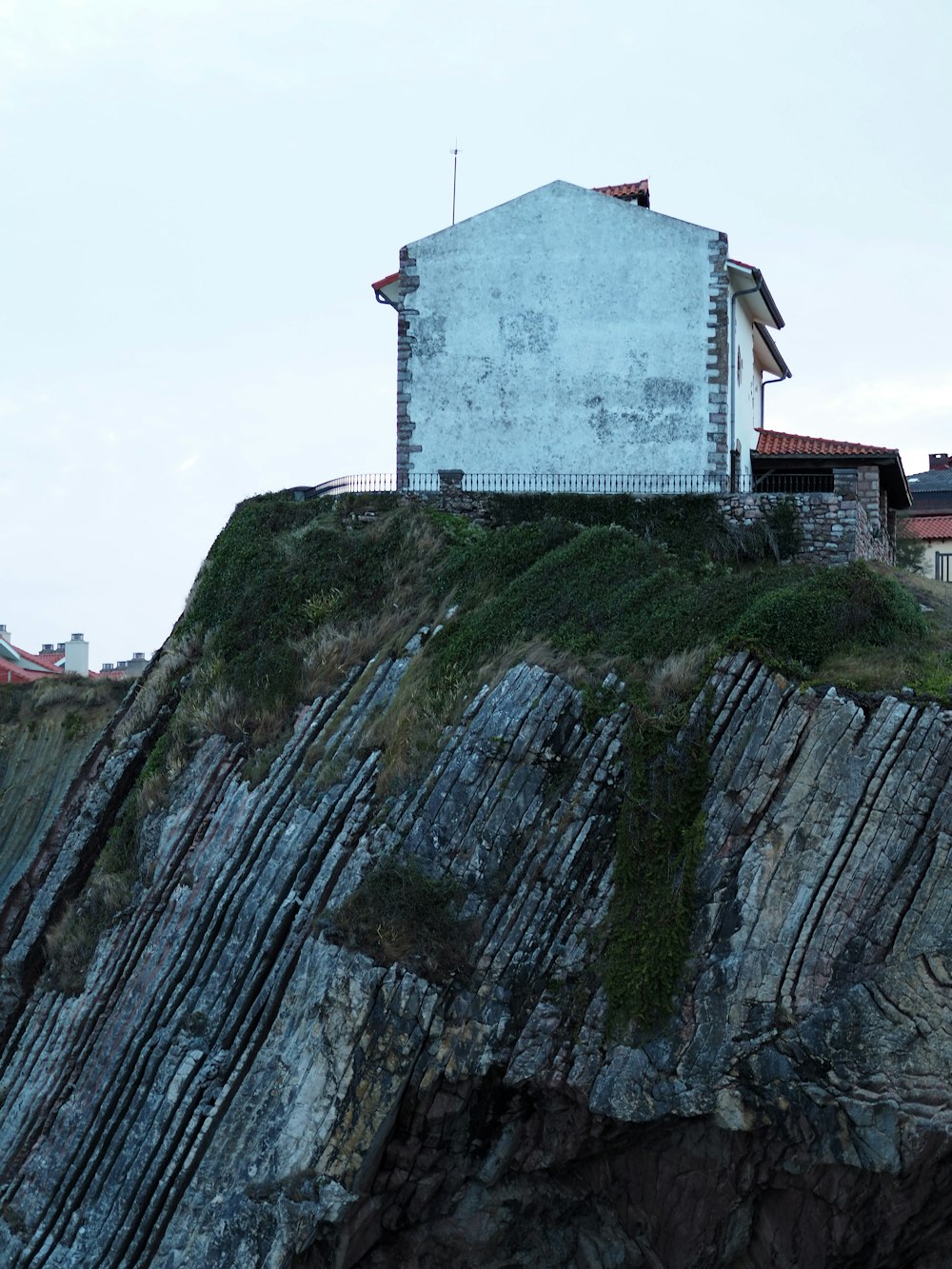 white concrete building on green mountain