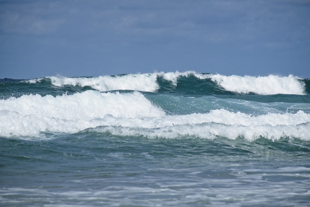 ocean waves under blue sky during daytime