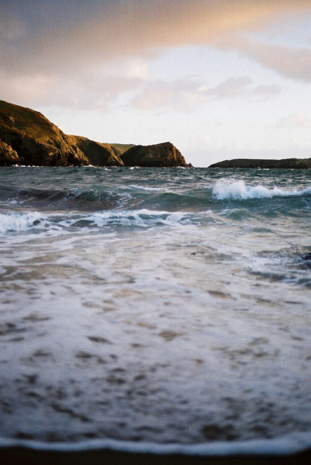 ocean waves crashing on shore during daytime