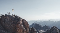 A scenic Colorado mountain trail with a small group walking together, symbolizing faith’s journey.