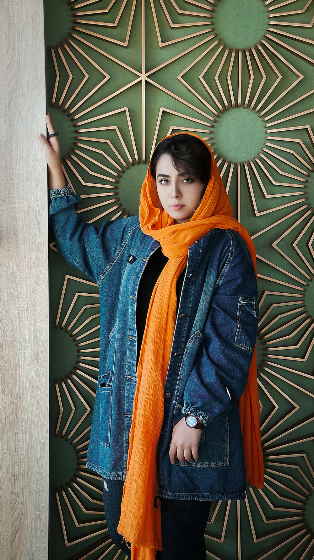 woman in blue denim jacket and orange scarf