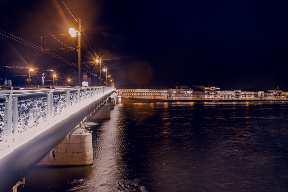 white bridge over water during night time