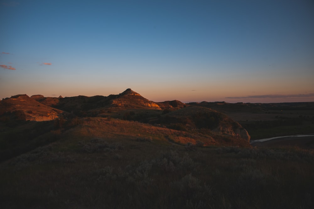 brown mountain under blue sky during daytime