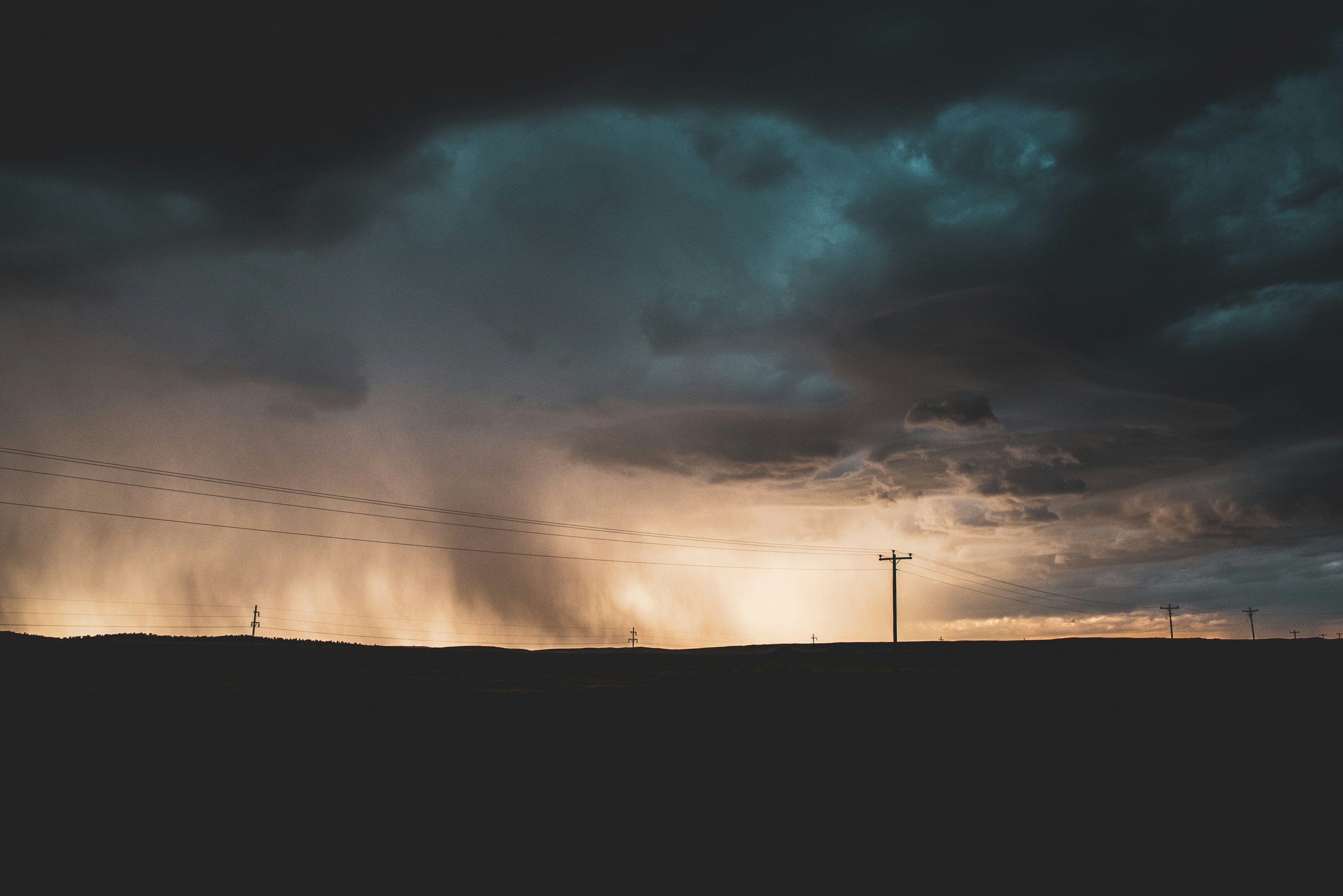 silhouette of mountain under cloudy sky during daytime