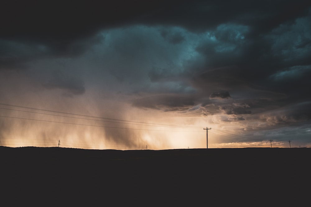 silhouette of mountain under cloudy sky during daytime