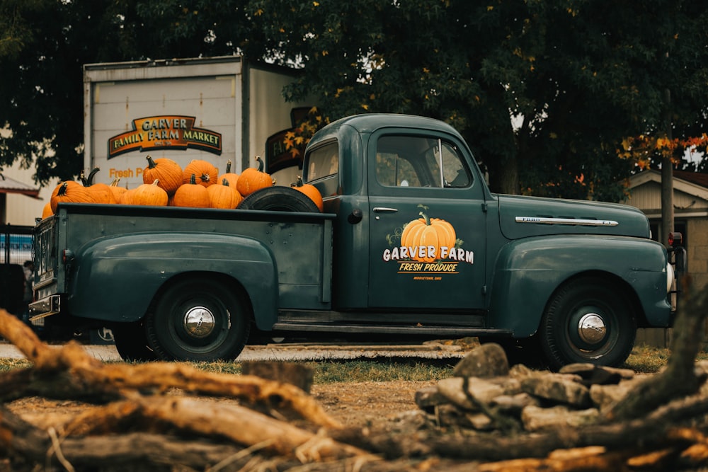 blue single cab pickup truck with pumpkins on top