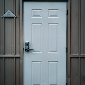 white wooden door with black door lever