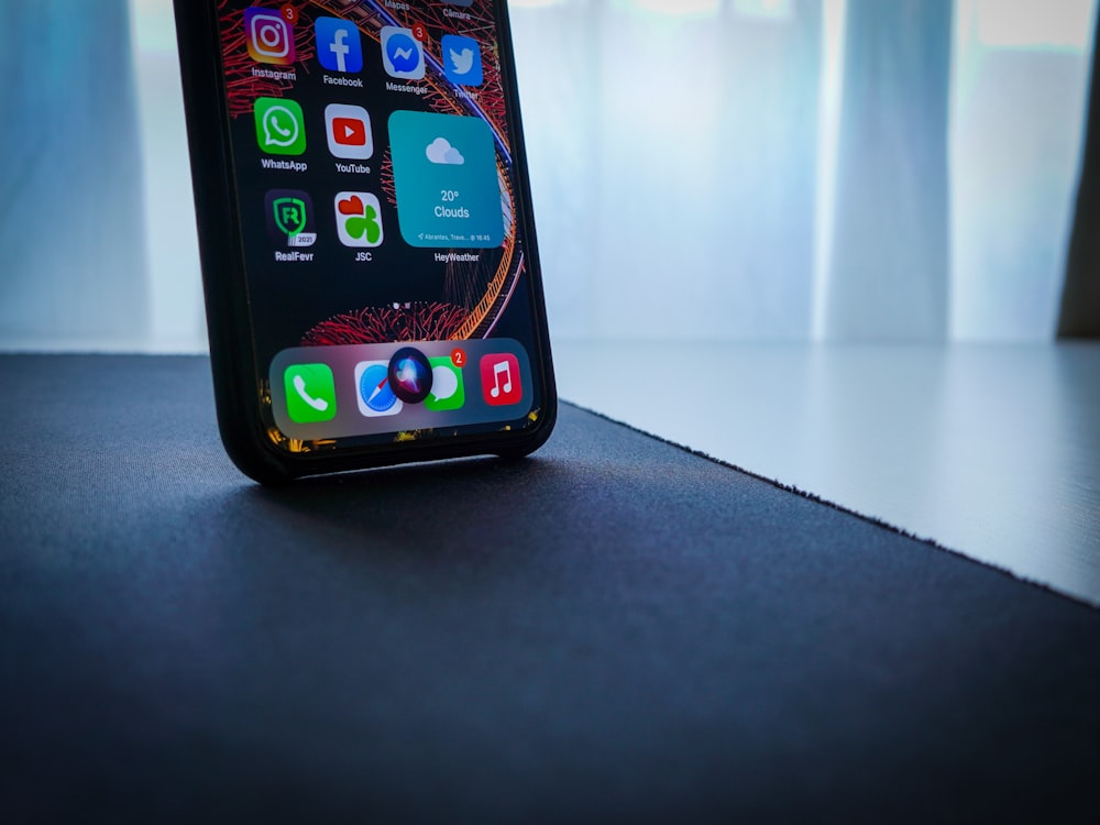 black iphone 5 on black table