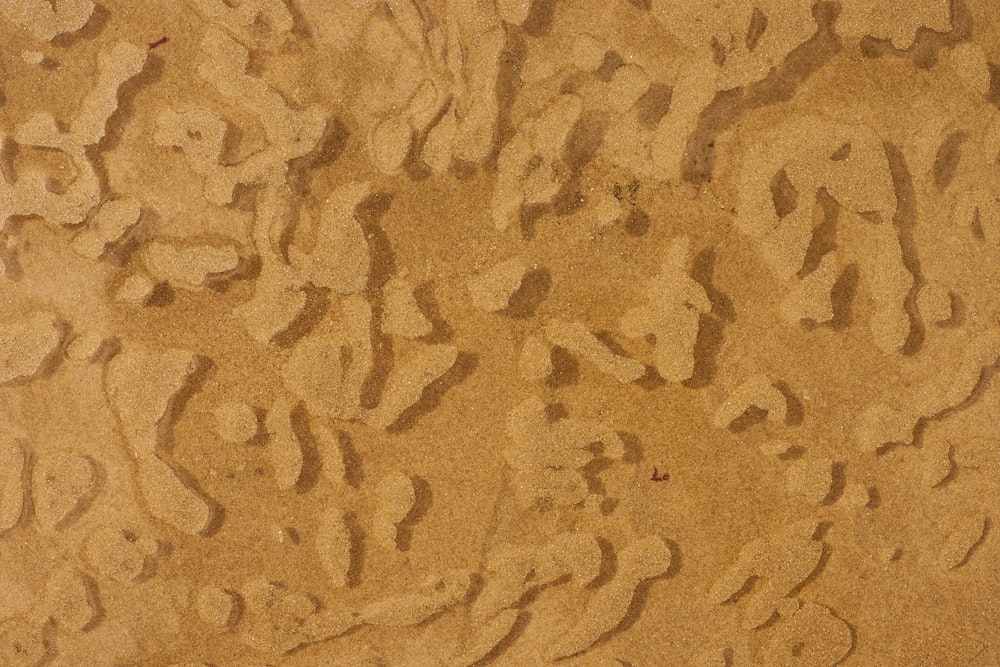 brown and black sand during daytime