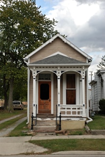 A welcoming front porch of a vacation rental with a contractor's truck parked outside.