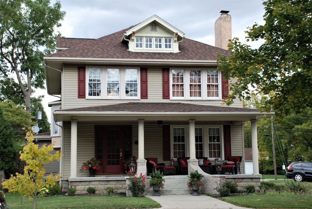 white and red wooden house near green trees during daytime