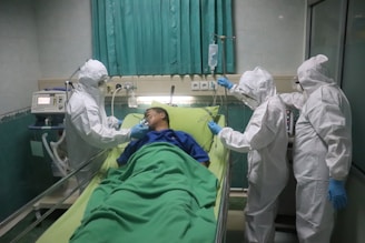 man in white scrub suit lying on hospital bed