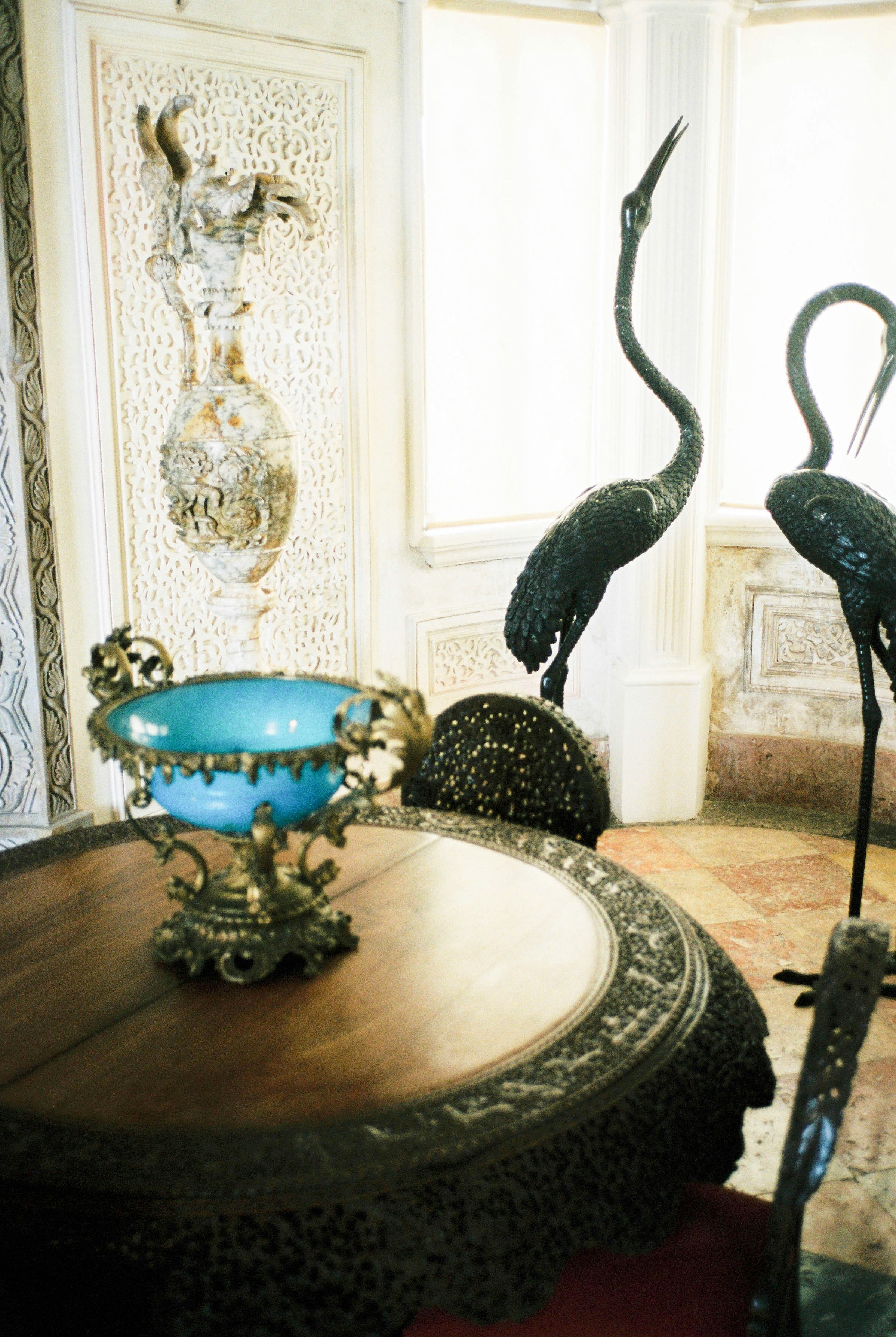 black and blue ceramic bird figurine on brown wooden table