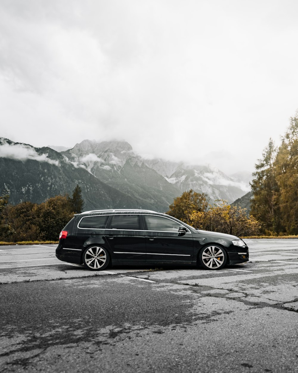 black sedan on road near snow covered mountain during daytime