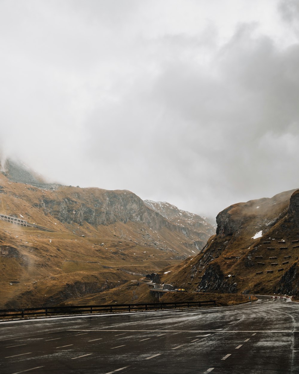 brown and green mountains under white clouds during daytime