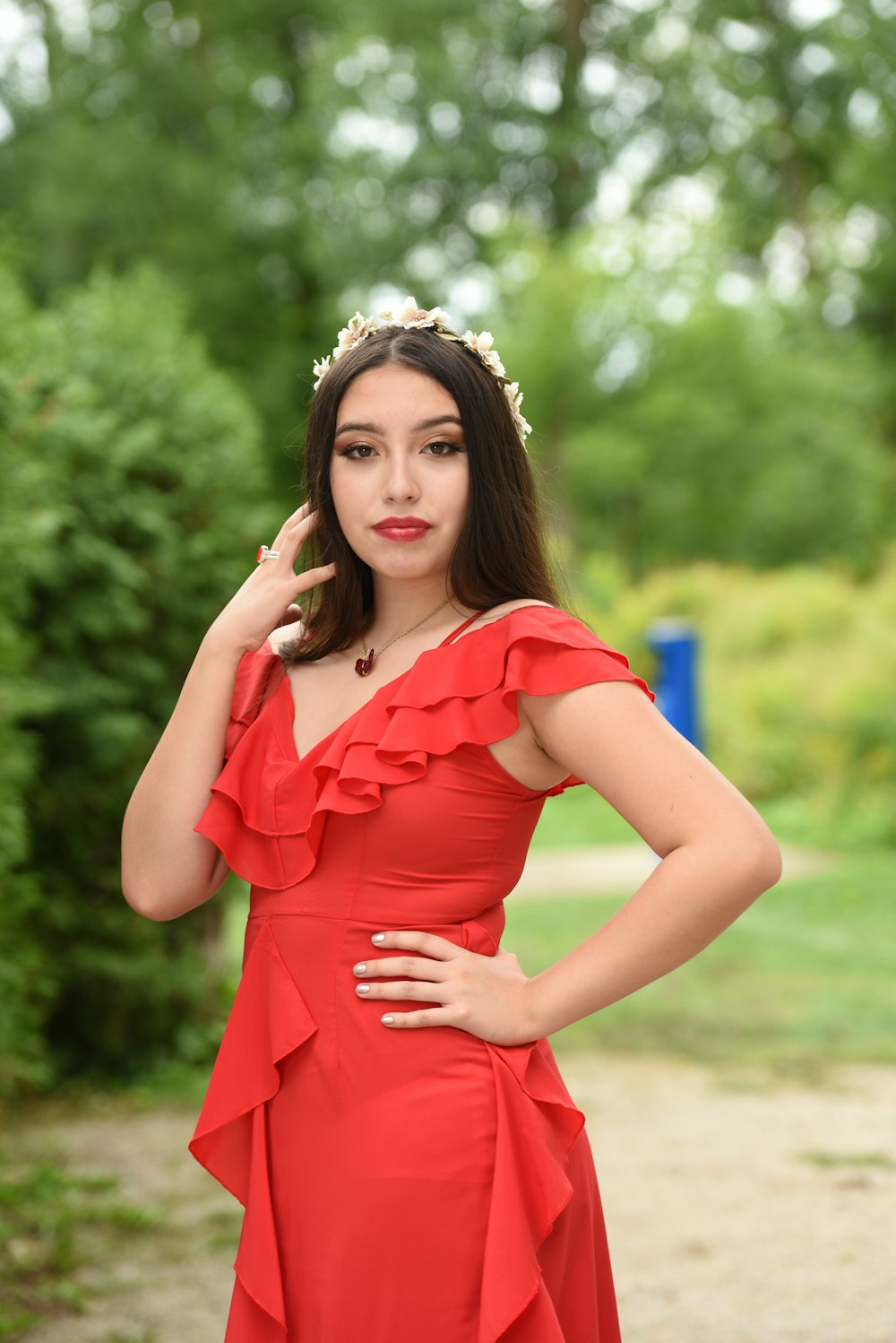 woman in orange dress wearing white floral crown