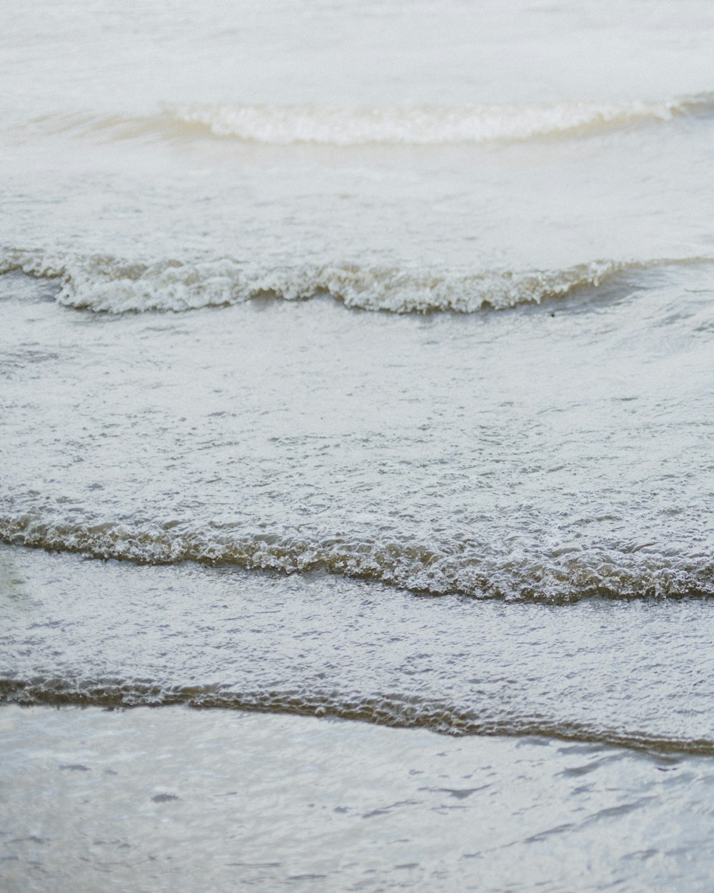 ocean waves crashing on shore during daytime