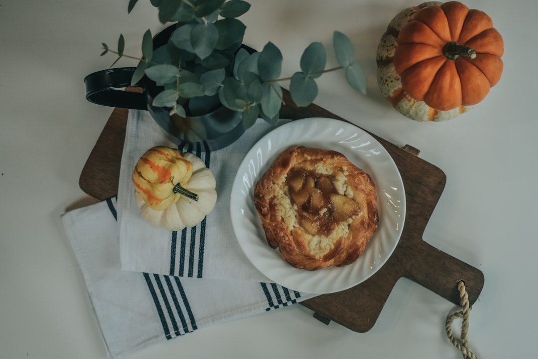 bread on white ceramic plate beside stainless steel fork and knife