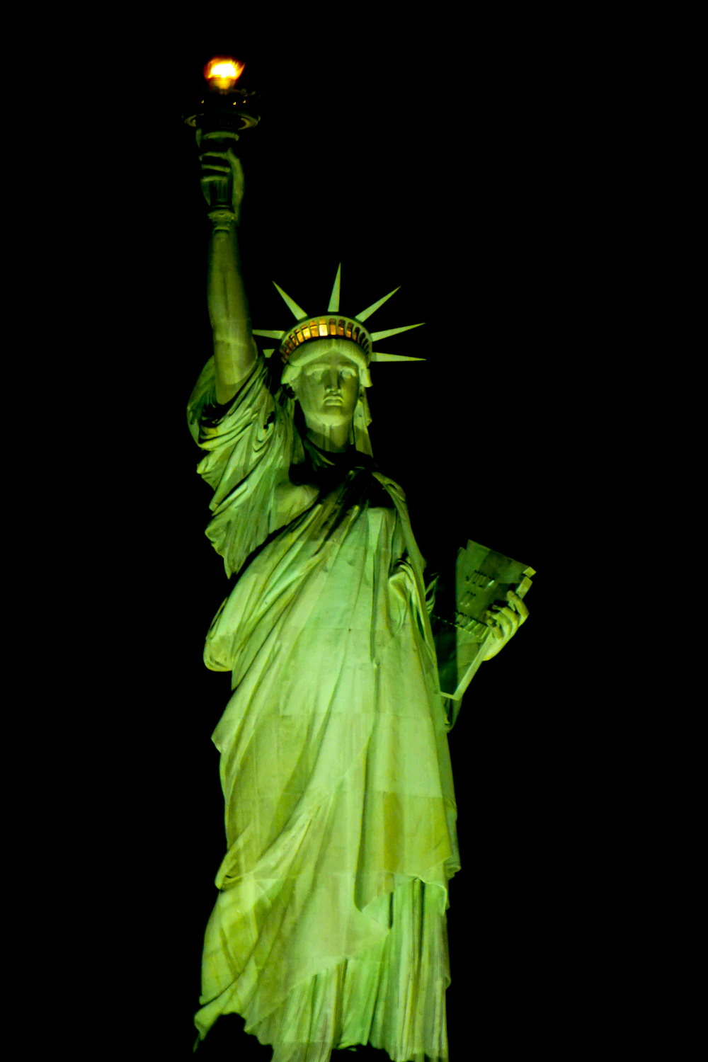 The Statue of Liberty illuminated at night in New York