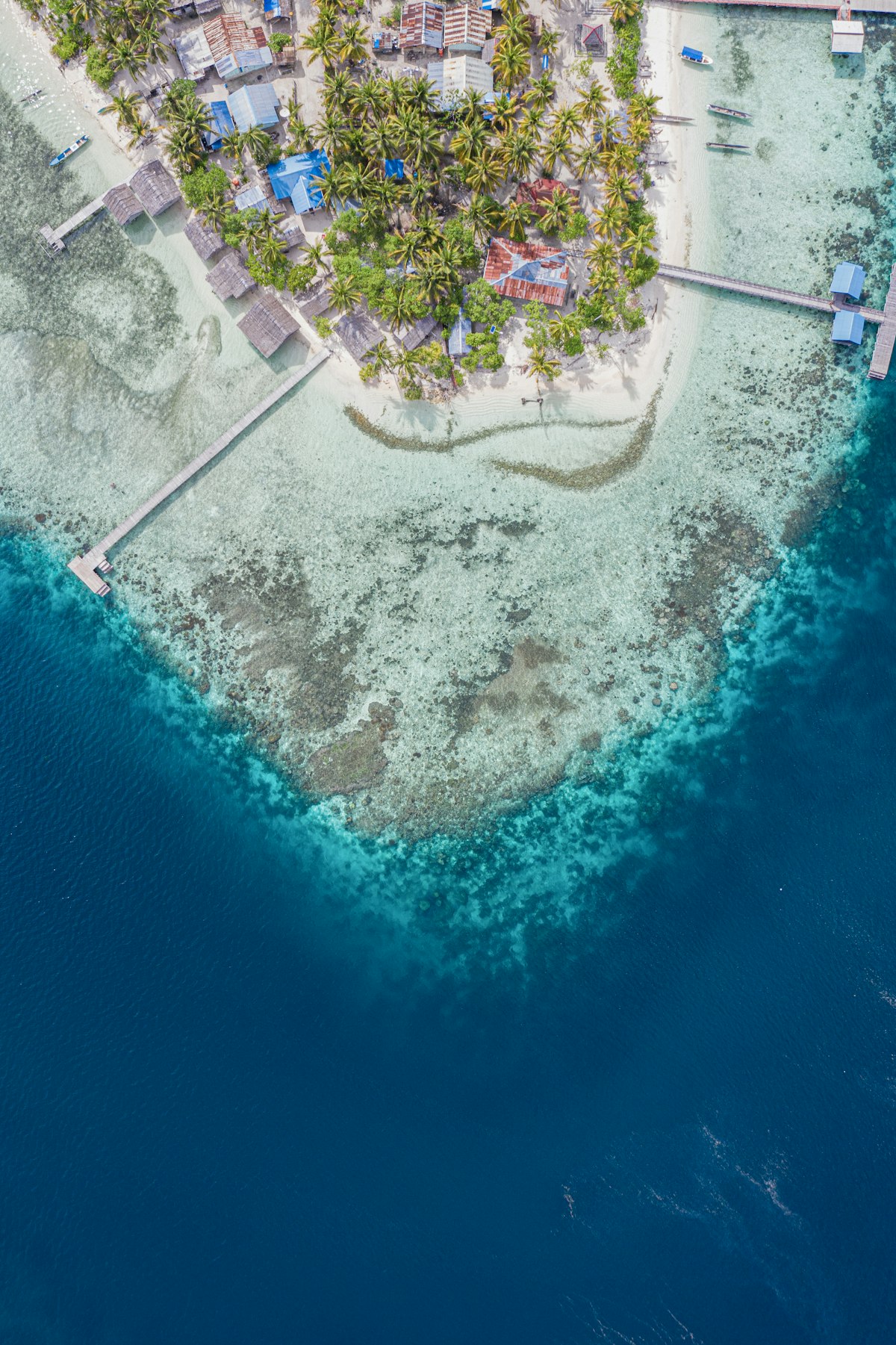 Aerial view of Raja Ampat island with turquoise reef waters, Dampier Strait